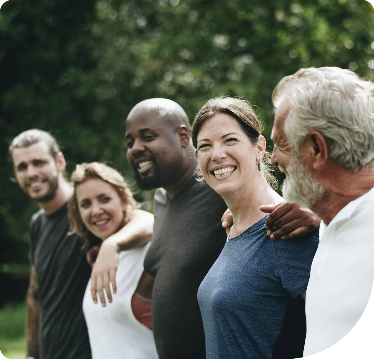 Group of people smiling outdoors together.